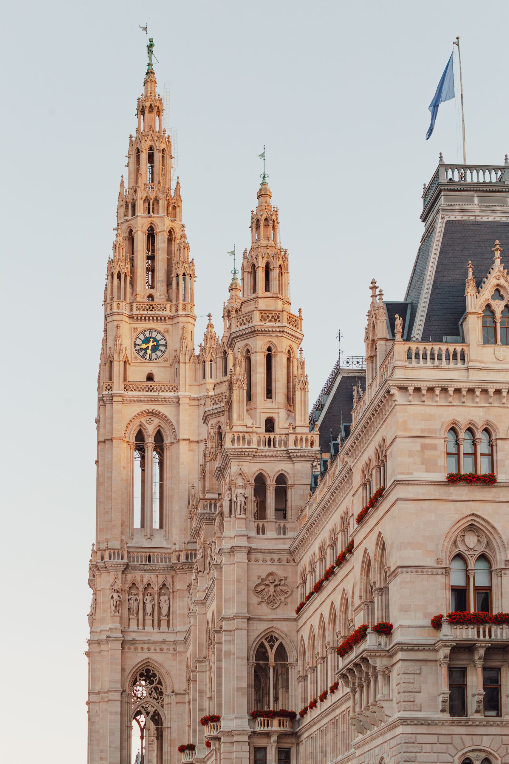 Stunning view of the Gothic Revival styled Vienna City Hall's facade and tower under a clear sky.